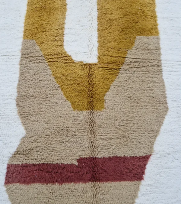 Detailed View of Soma handmade Beni Ourain wool rug with a modern abstract design featuring blocks of yellow, beige, and maroon
