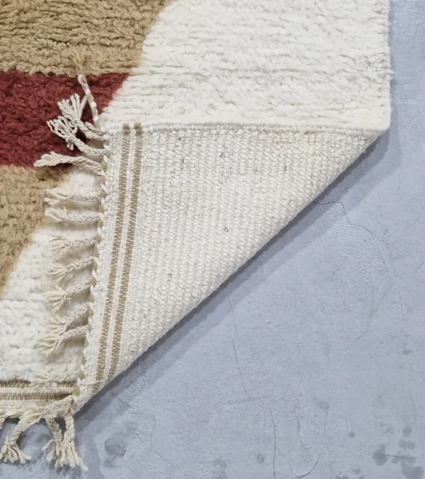 Detailed View of Soma handmade Beni Ourain wool rug with a modern abstract design featuring blocks of yellow, beige, and maroon