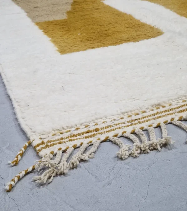 Detailed View of Soma handmade Beni Ourain wool rug with a modern abstract design featuring blocks of yellow, beige, and maroon