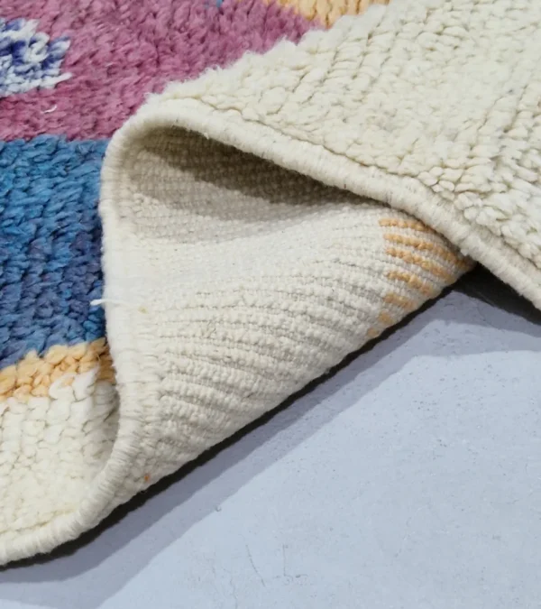 Detailed View of Soraya handmade Azilal wool runner with an abstract geometric design in pink, yellow, blue, and navy