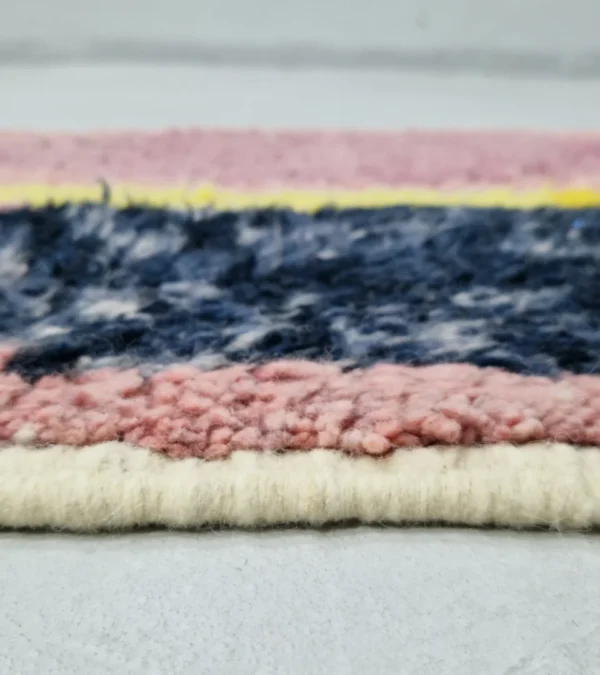Zoomed In View of Soraya handmade Azilal wool runner with an abstract geometric design in pink, yellow, blue, and navy