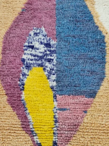 Detailed View of Soraya handmade Azilal wool runner with an abstract geometric design in pink, yellow, blue, and navy