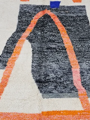 Detailed View of Soraya handmade Beni Ourain wool rug with a minimalist geometric design in dark gray, burnt orange, and bright blue on an ivory background