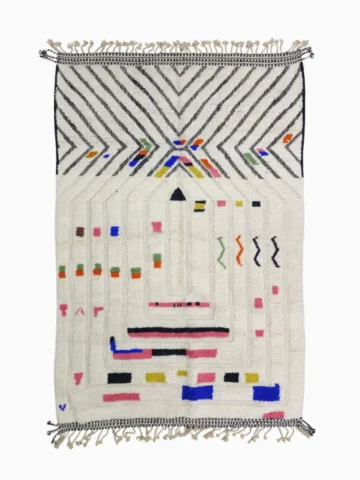 Top View of Suzan handmade Beni Ourain wool rug with a bold chevron and abstract raised maze design in black and multicolor on an ivory background