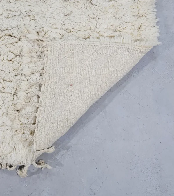 Detailed View of Handmade Moroccan Beni Ourain wool rug with a minimalist geometric pattern and extra soft shag pile in a natural ivory color