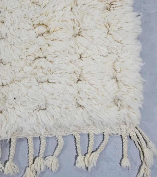 Detailed View of Handmade Moroccan Beni Ourain wool rug with a minimalist geometric pattern and extra soft shag pile in a natural ivory color