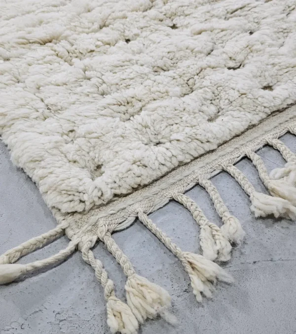 Detailed View of Handmade Moroccan Beni Ourain wool rug with a minimalist geometric pattern and extra soft shag pile in a natural ivory color
