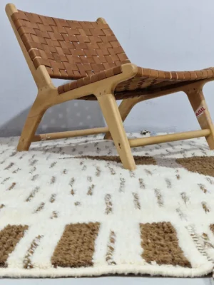 Talia handmade Beni Ourain wool rug with a textured plush design in cloud ivory, black, and brown in room