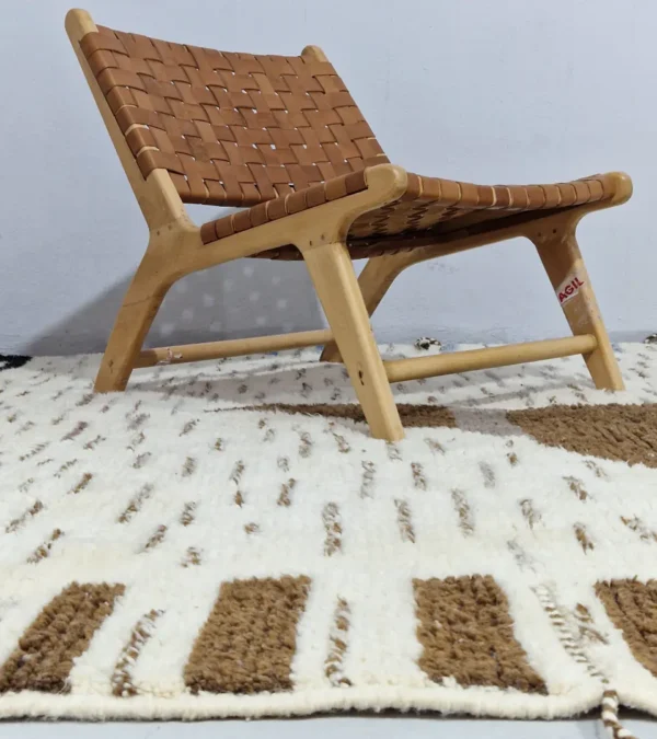 Talia handmade Beni Ourain wool rug with a textured plush design in cloud ivory, black, and brown in room