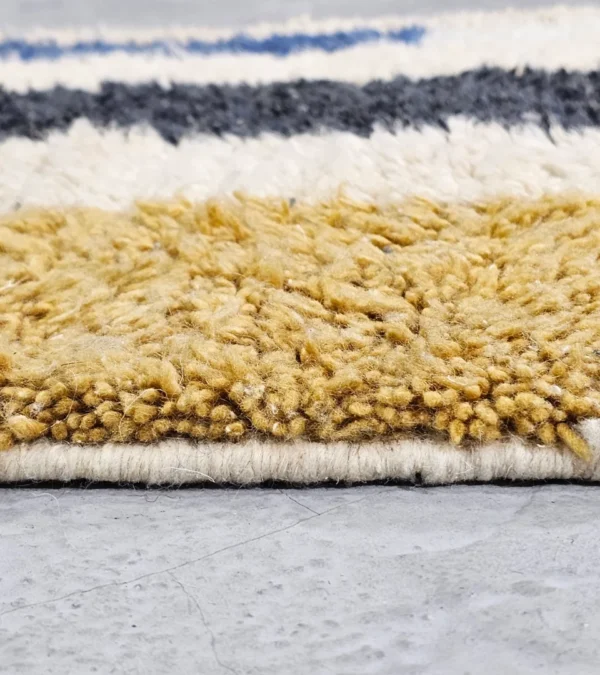 Zoomed In View of Tareen handmade Beni Ourain wool runner with a colorful lines design in brown, teal-blue, dusty blue, mustard yellow, and ivory