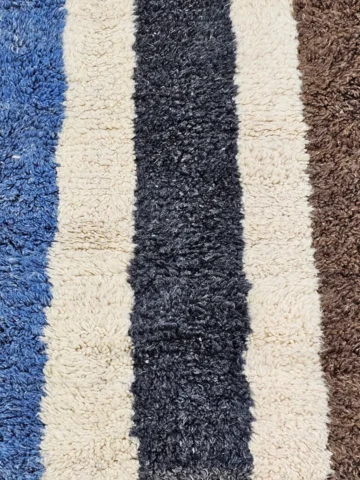 Detailed View Of Tareen handmade Beni Ourain wool runner with a colorful lines design in brown, teal-blue, dusty blue, mustard yellow, and ivory