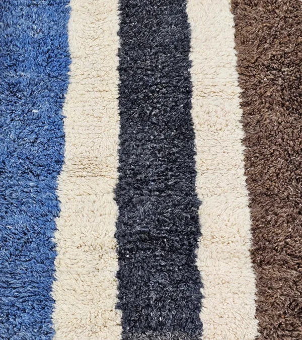 Detailed View Of Tareen handmade Beni Ourain wool runner with a colorful lines design in brown, teal-blue, dusty blue, mustard yellow, and ivory