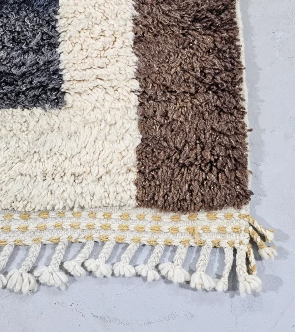Detailed View Of Tareen handmade Beni Ourain wool runner with a colorful lines design in brown, teal-blue, dusty blue, mustard yellow, and ivory