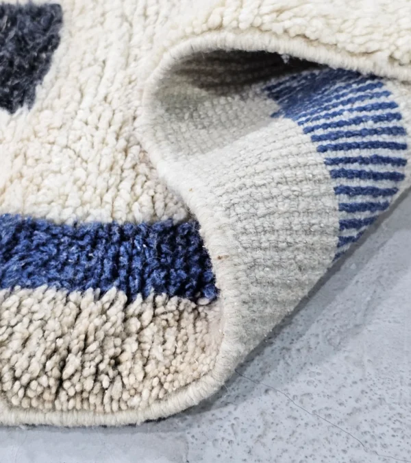 Detailed View Of Tareen handmade Beni Ourain wool runner with a colorful lines design in brown, teal-blue, dusty blue, mustard yellow, and ivory