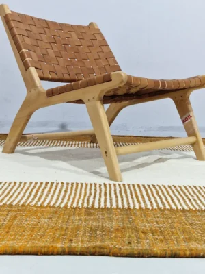 Taya handmade Kilim flatweave wool rug with a brown striped border and a large white central rectangle in room