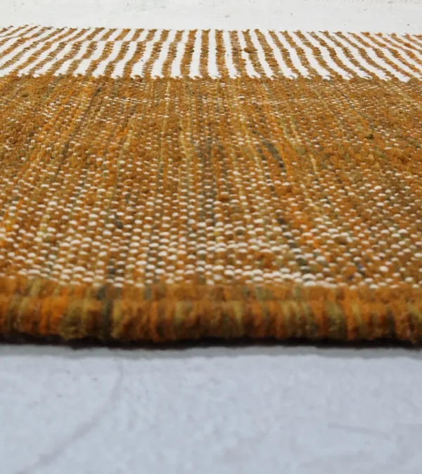 Zoomed In View of Taya handmade Kilim flatweave wool rug with a brown striped border and a large white central rectangle