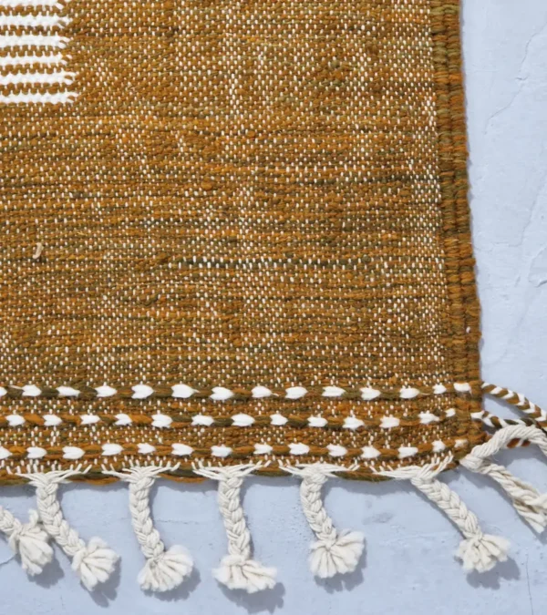 Detailed View of Taya handmade Kilim flatweave wool rug with a brown striped border and a large white central rectangle