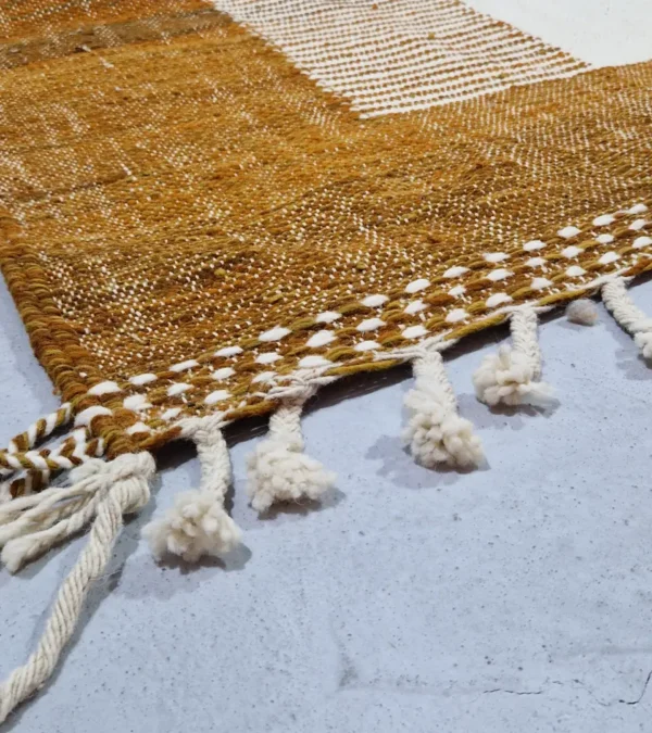 Detailed View of Taya handmade Kilim flatweave wool rug with a brown striped border and a large white central rectangle