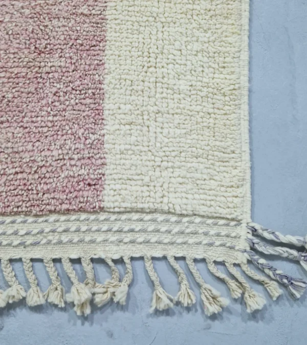 Detailed View of Handmade Moroccan plush wool rug with a modern cloud-like abstract design in muted pink, yellow, and gray