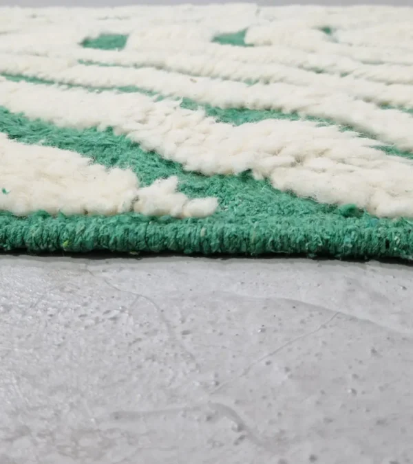 Zoomed In View of Verdant handmade Beni Ourain wool rug with a bold pattern of nested green and ivory stripes