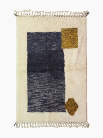 Top View of Yara handmade Beni Ourain wool rug with a modern geometric pattern and tassel fringe in charcoal gray, mustard yellow-brown, and ivory