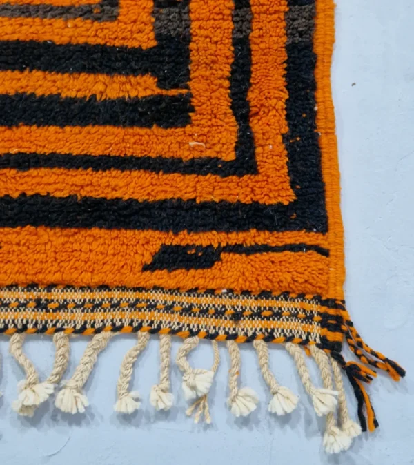 Detailed View of Handmade Moroccan wool rug with orange and navy concentric square stripes