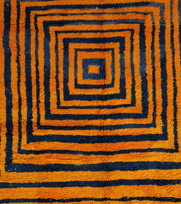 Detailed View of Handmade Moroccan wool rug with orange and navy concentric square stripes