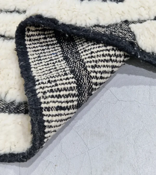 Detailed View of Zebra handmade Beni Ourain wool rug with a bold black and white striped pattern and varying pile height