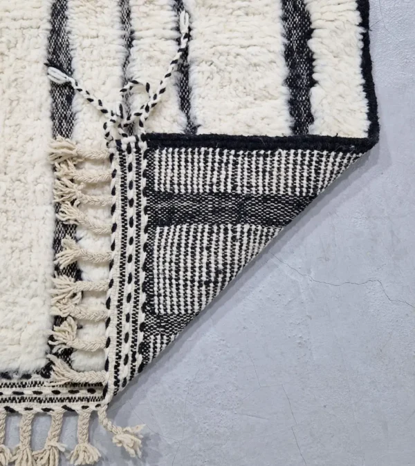 Detailed View of Zebra handmade Beni Ourain wool rug with a bold black and white striped pattern and varying pile height