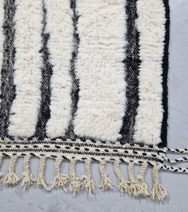 Detailed View of Zebra handmade Beni Ourain wool rug with a bold black and white striped pattern and varying pile height