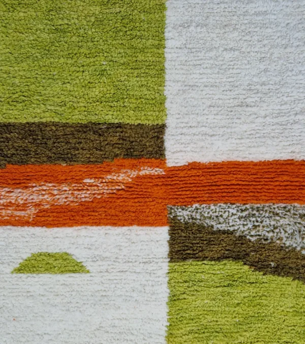 Detailed View of Zera handmade Beni Ourain wool rug with a contemporary abstract design in multicolor hues of green, orange, and brown