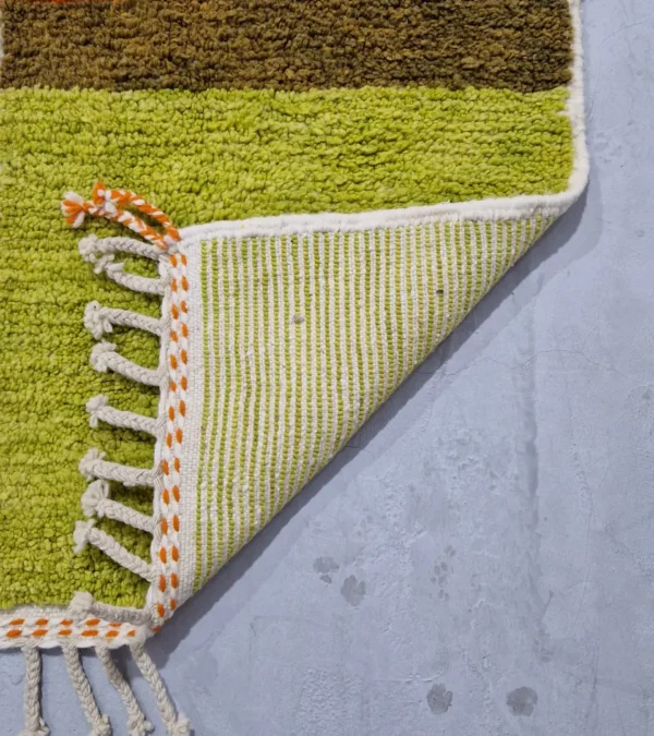 Detailed View of Zera handmade Beni Ourain wool rug with a contemporary abstract design in multicolor hues of green, orange, and brown