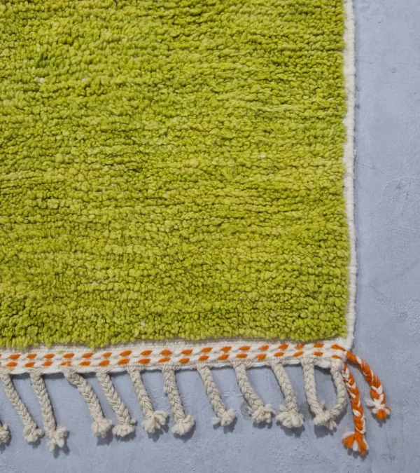 Detailed View of Zera handmade Beni Ourain wool rug with a contemporary abstract design in multicolor hues of green, orange, and brown