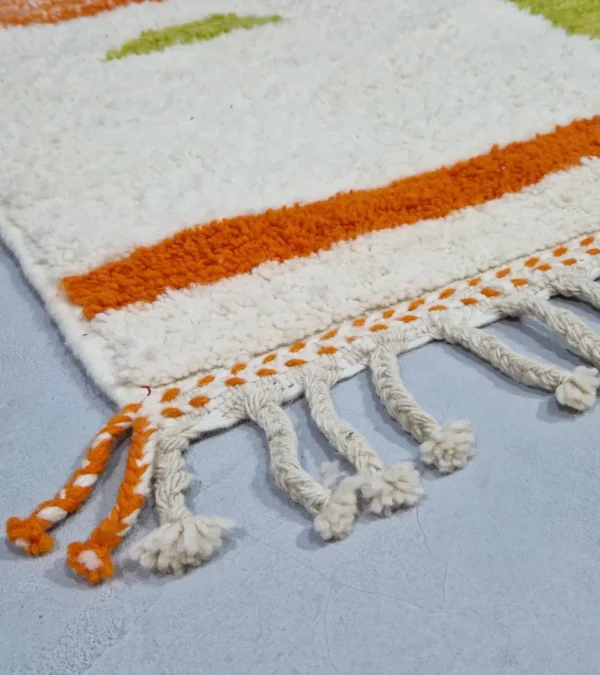 Detailed View of Zera handmade Beni Ourain wool rug with a contemporary abstract design in multicolor hues of green, orange, and brown