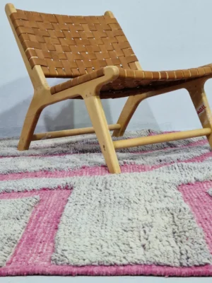 Handmade Moroccan Beni Mrirt wool rug with unique abstract and geometric pink and gray shaggy pattern in room