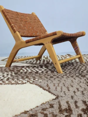 Zira handmade Beni Ourain wool rug with a textured geometric design in brown, gray, and ivory in room