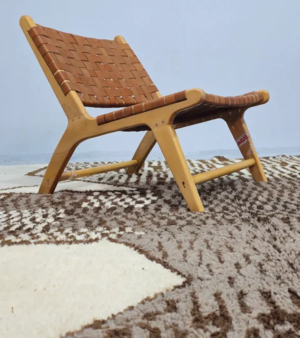 Zira handmade Beni Ourain wool rug with a textured geometric design in brown, gray, and ivory in room
