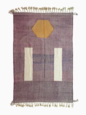 Top View of Zola handmade Kilim flatweave wool rug with a purple background and white and yellow geometric shapes