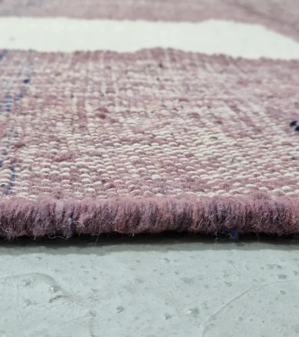 Zoomed In View of Zola handmade Kilim flatweave wool rug with a purple background and white and yellow geometric shapes