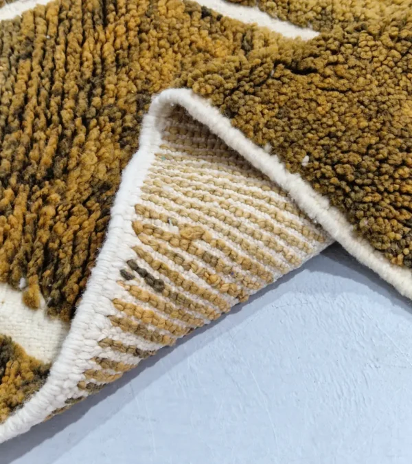 Detailed View of Zola handmade Moroccan wool rug with a modern lattice pattern in brown and ivory