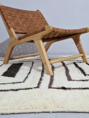 Zola handmade Beni Ourain wool rug with a minimalist design of bold black lines on an ivory background in room