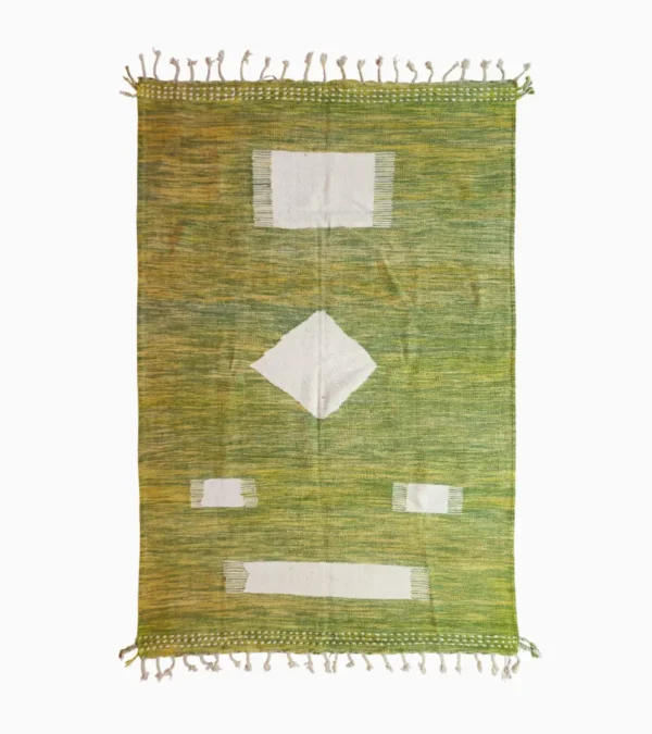 Top View of Zuri handmade Kilim flatweave rug with a minimalist textured design and geometric shapes on a green background