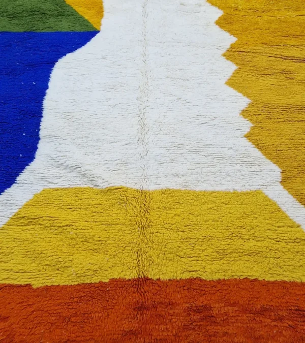 detailed view of Abstract color block Moroccan wool rug with yellow, blue, orange, and ivory panels