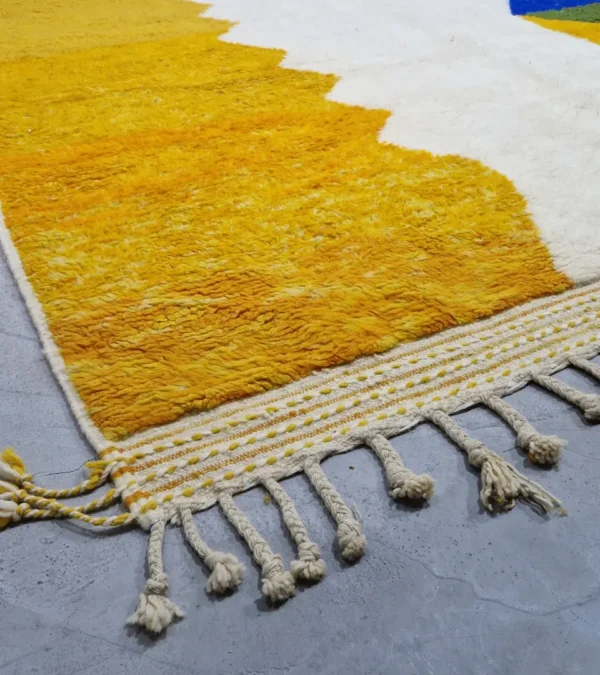 detailed view of Abstract color block Moroccan wool rug with yellow, blue, orange, and ivory panels