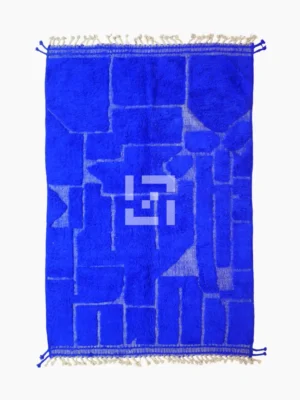 top view of Handmade Moroccan wool rug in a vibrant blue with a subtle geometric pattern created by varied pile height
