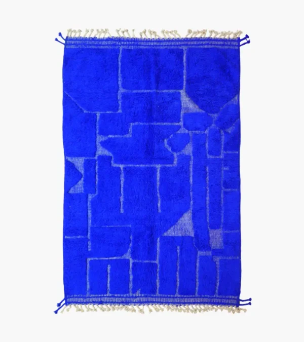 top view of Handmade Moroccan wool rug in a vibrant blue with a subtle geometric pattern created by varied pile height