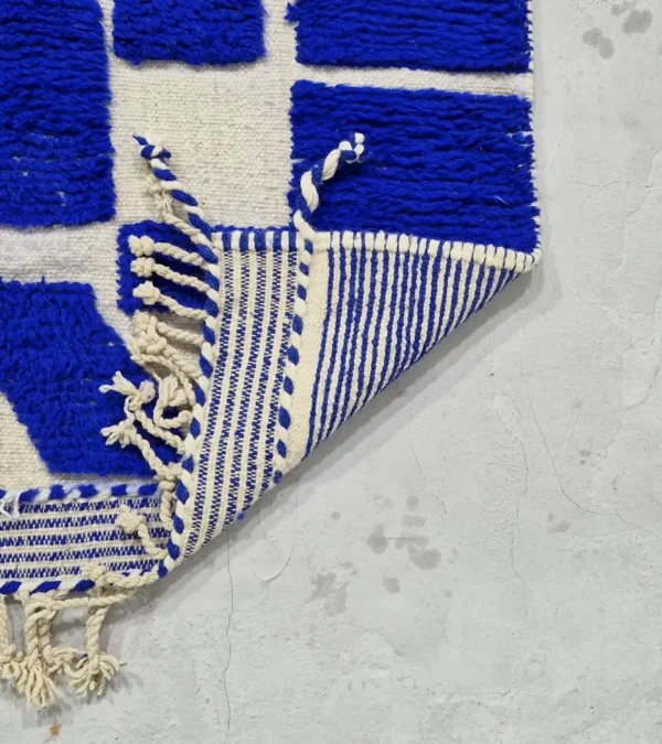 detailed view of Handwoven cobalt blue abstract geometric Moroccan rug with shaggy pile