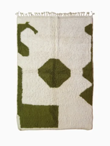 top view of Handcrafted Moroccan shaggy rug with cream base, green abstract shapes, and central diamond motif