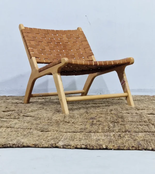 Handwoven earth gray wool rug with subtle geometric grid pattern in room