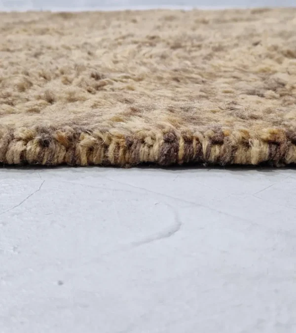 zoomed in view of Handwoven earth gray wool rug with subtle geometric grid pattern
